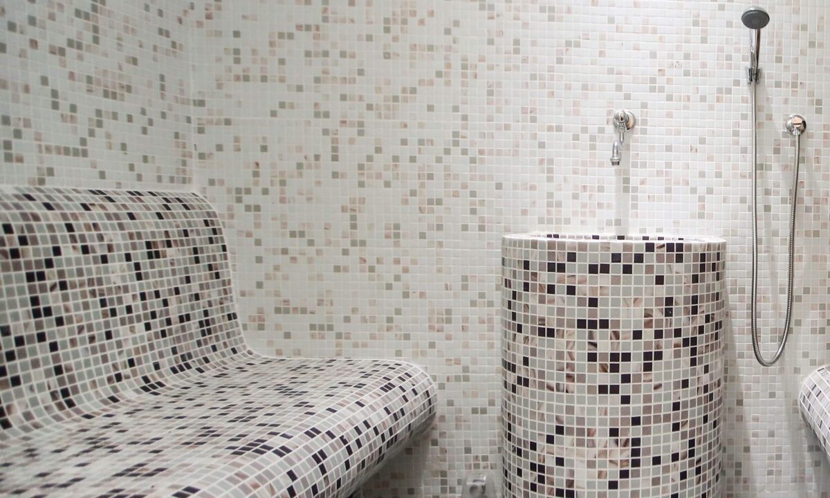 steam room with bench and faucet